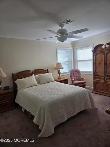 a spacious bedroom with two bed and a tv