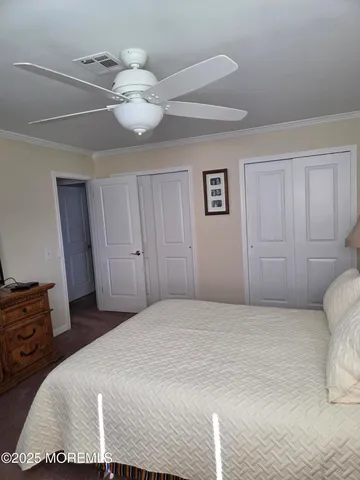 a bedroom with a bed and chandelier