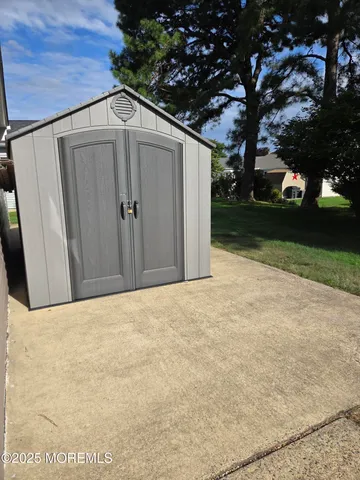 a backyard of a house with trees and covered with tall trees