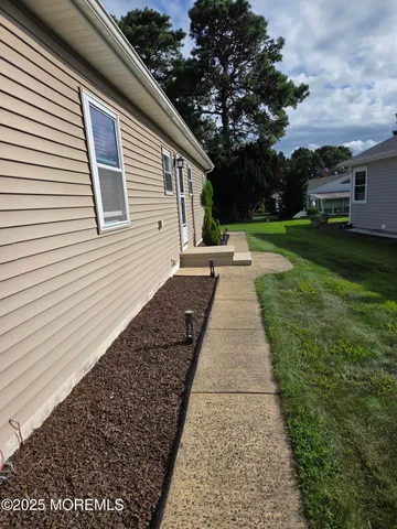 a view of backyard with barbeque grill and a small yard