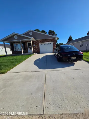 a car parked in front of a house with a yard