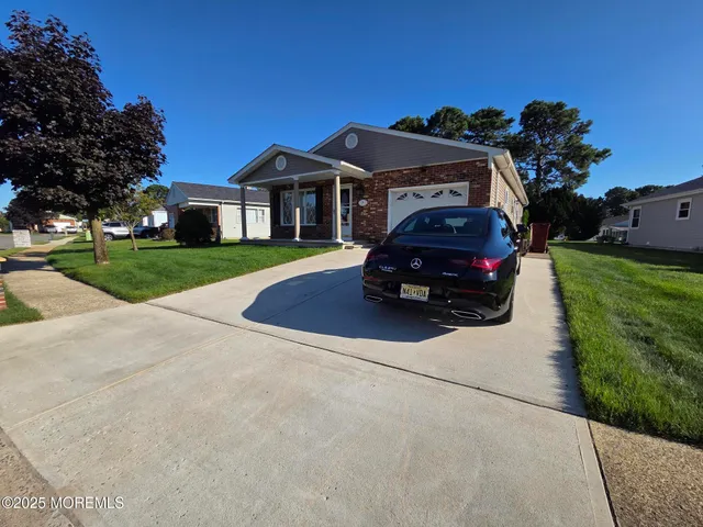 a car parked in front of a house and a yard