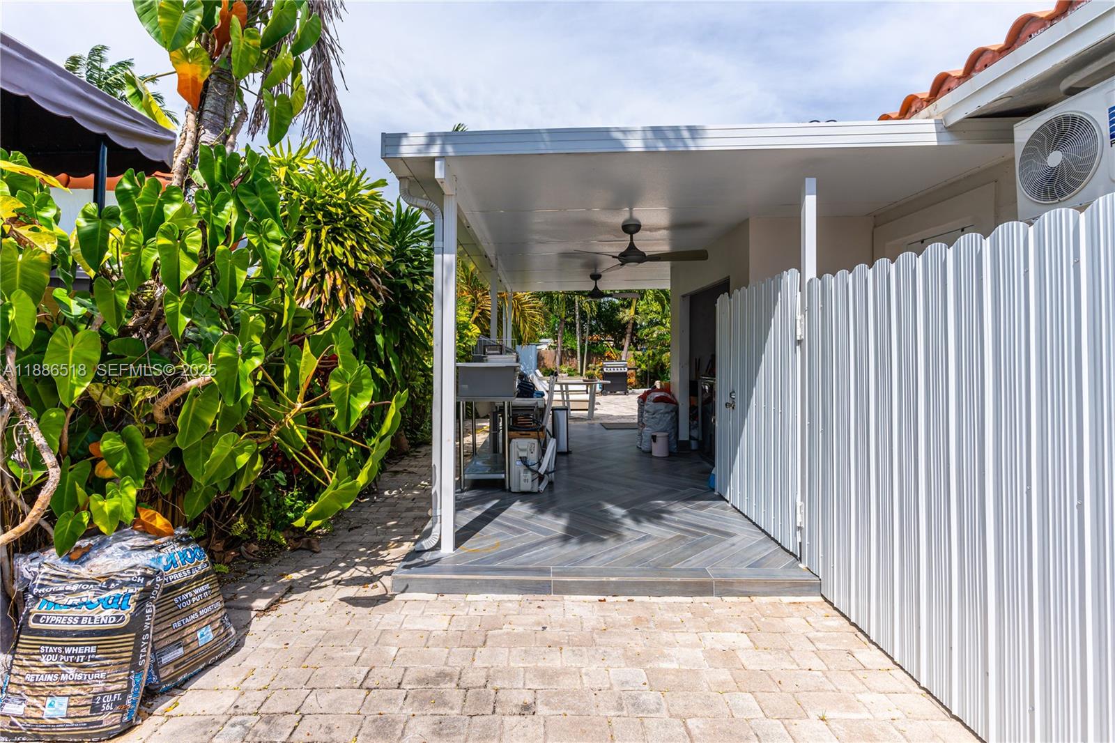 9901 Southwest 35th Terrace Miami, FL 33165 - Photo 16 of 39 a view of a patio with table and chairs and potted plants