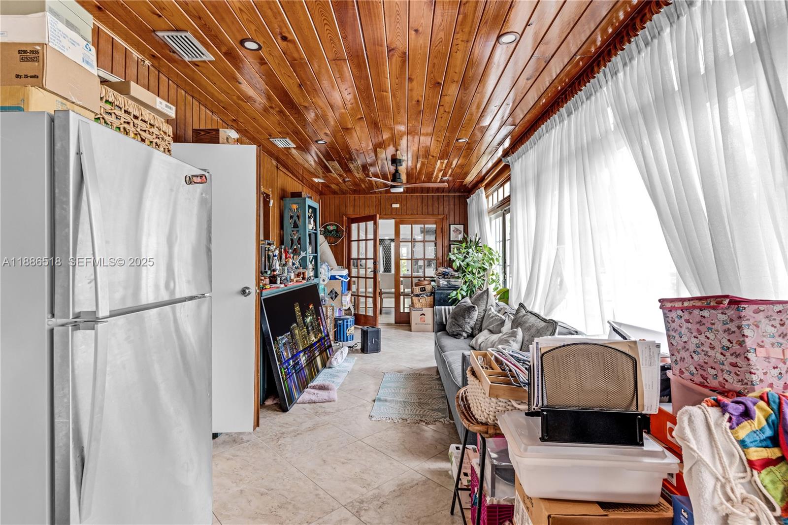 9901 Southwest 35th Terrace Miami, FL 33165 - Photo 31 of 39 a living room with furniture a fireplace and a large window