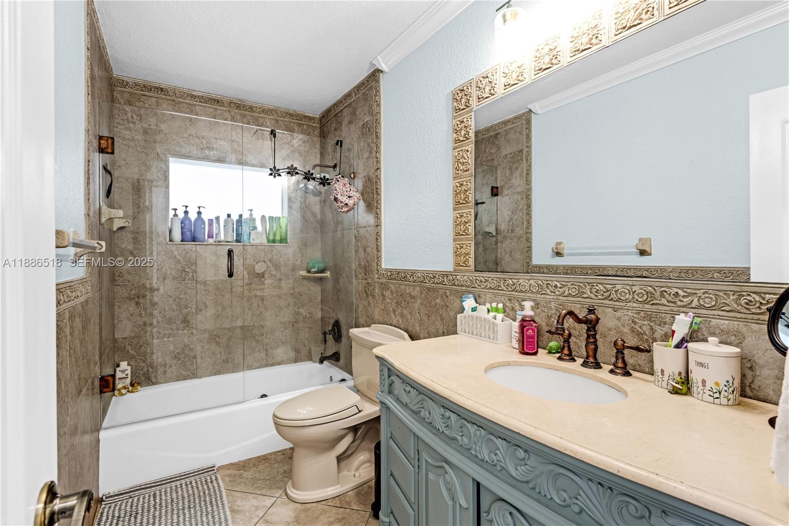 9901 Southwest 35th Terrace Miami, FL 33165 - Photo 35 of 39 a bathroom with a sink toilet tub and shower