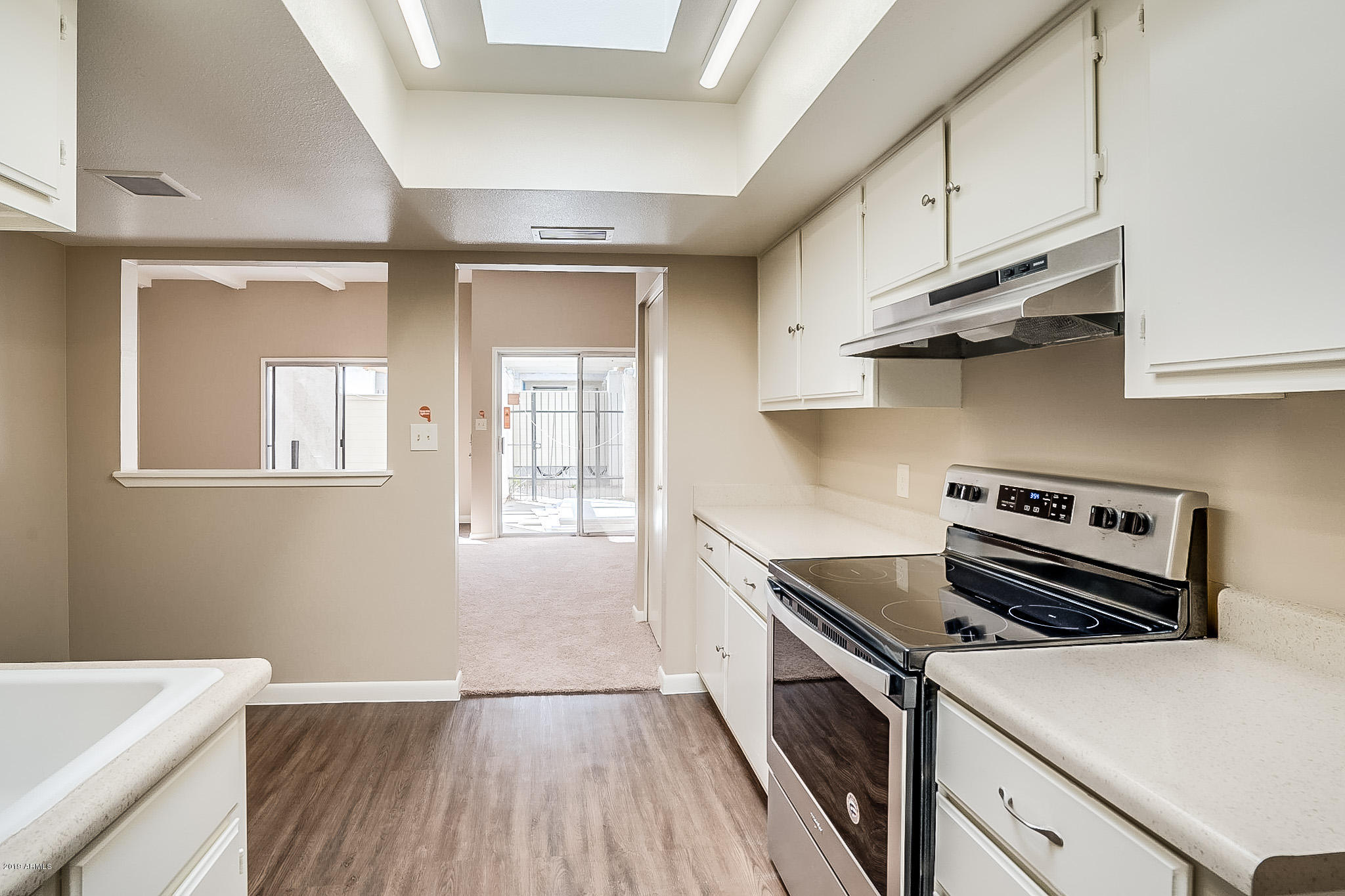 516 South Evergreen Road Tempe, AZ 85288 - Photo 7 of 16 a kitchen with a stove and a refrigerator