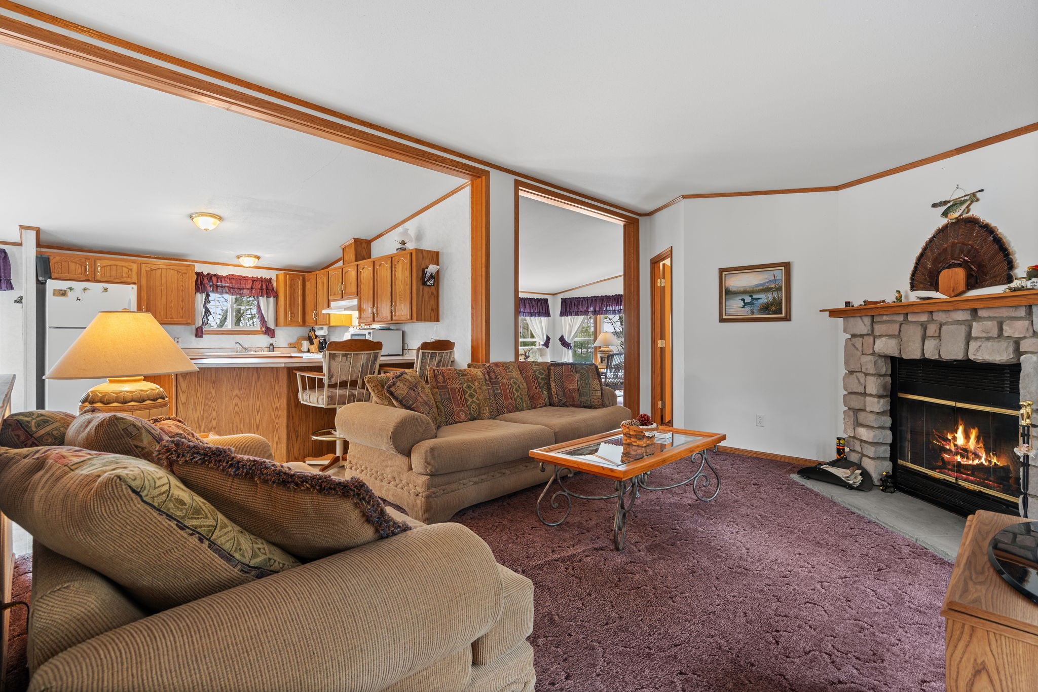 12503 Small Road Hayward, WI 54843 - Photo 36 of 36 Inviting and open floor plan with wood burning fireplace, generous size living room and kitchen with access into the sunroom/3rd bedroom.
