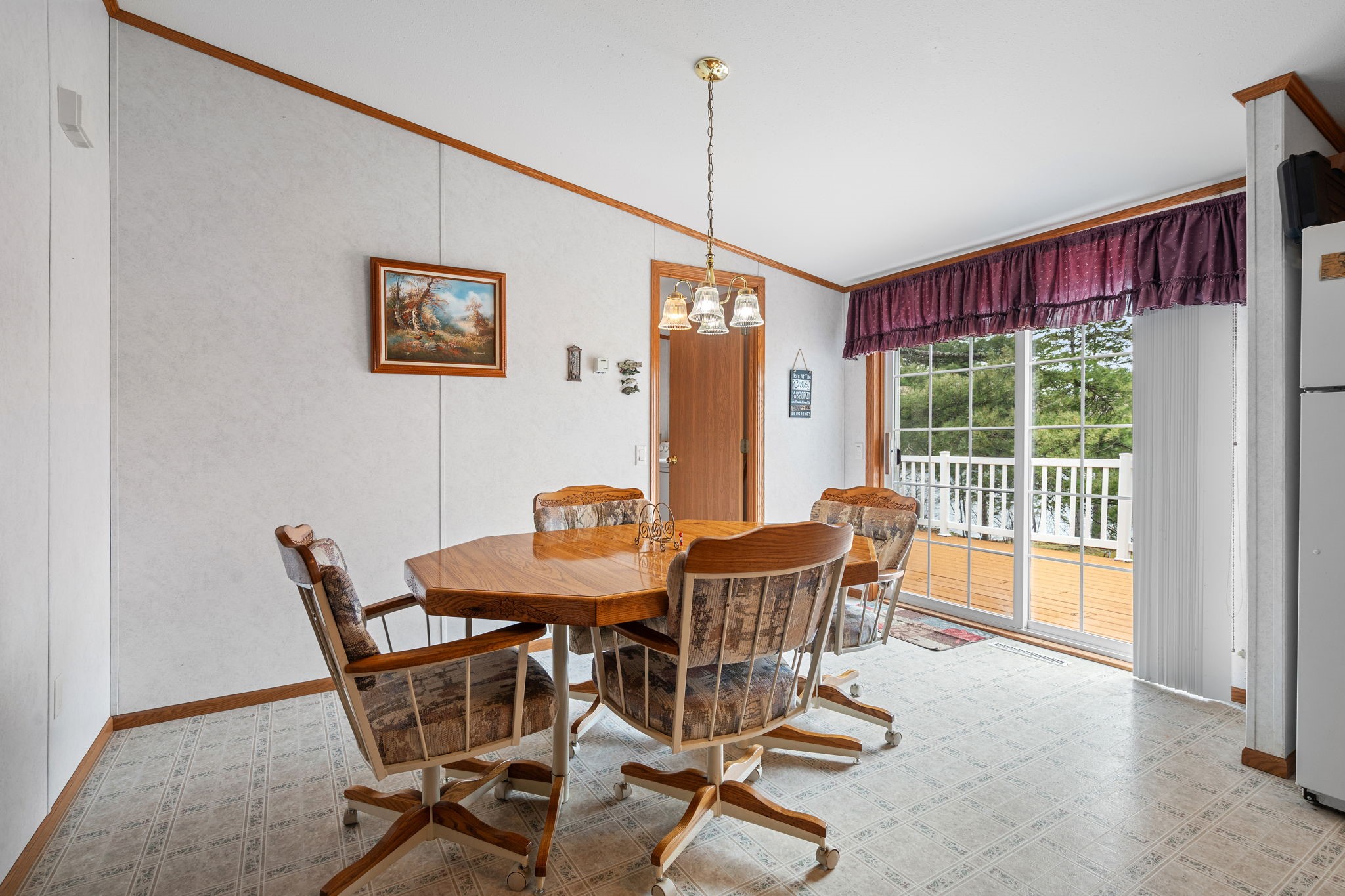 12503 Small Road Hayward, WI 54843 - Photo 25 of 36 The dining room leads to a freshly stained deck and fills the room with natural light.