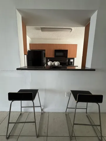 a living room with a chair and a flat screen tv