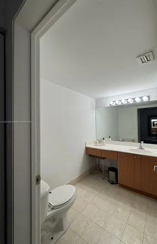 a view of a bathroom with a toilet sink and mirror