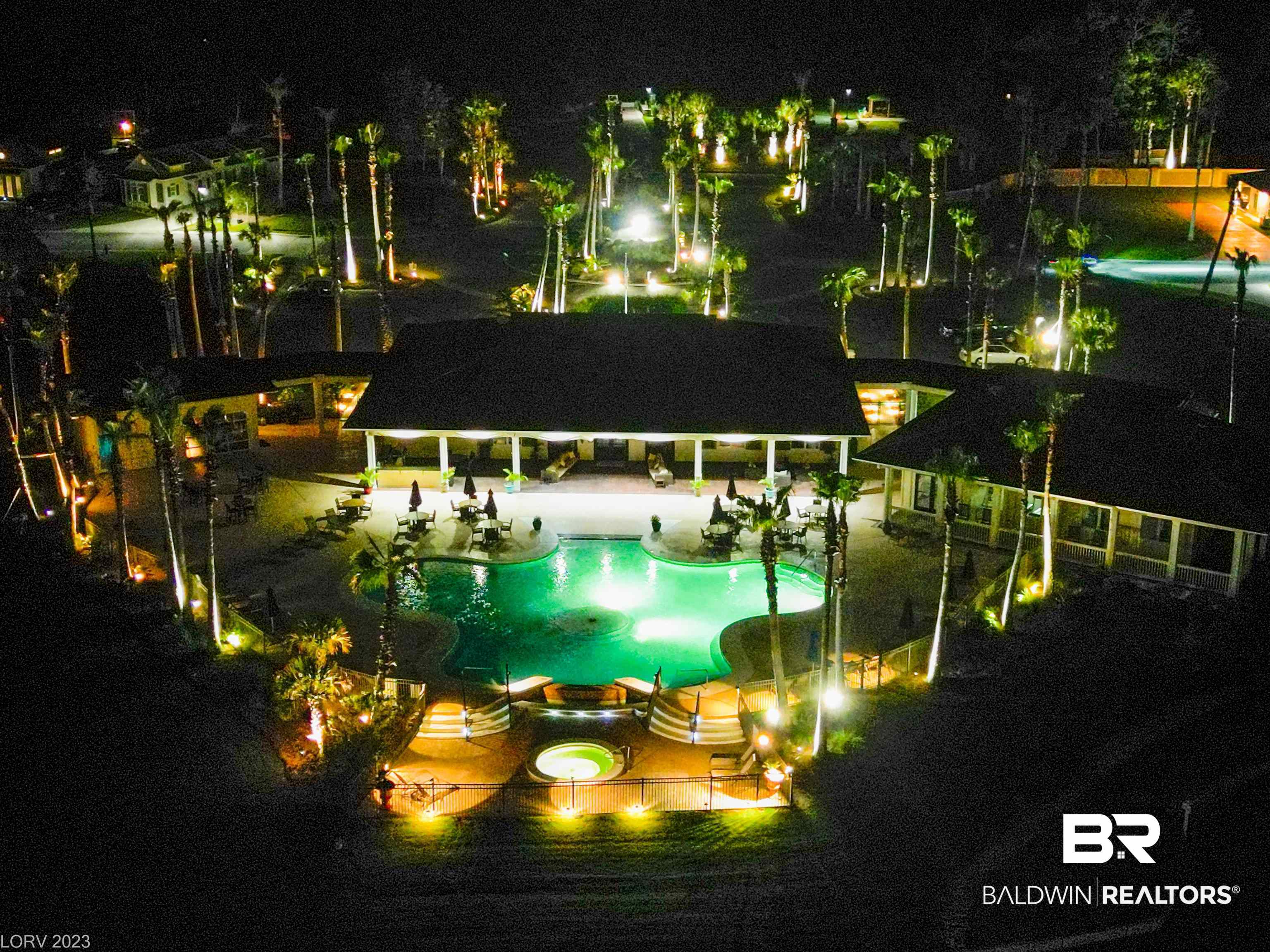 12489 Gateway Drive Elberta, AL 36530 - Photo 27 of 55 Pool at night featuring a patio area and a community pool