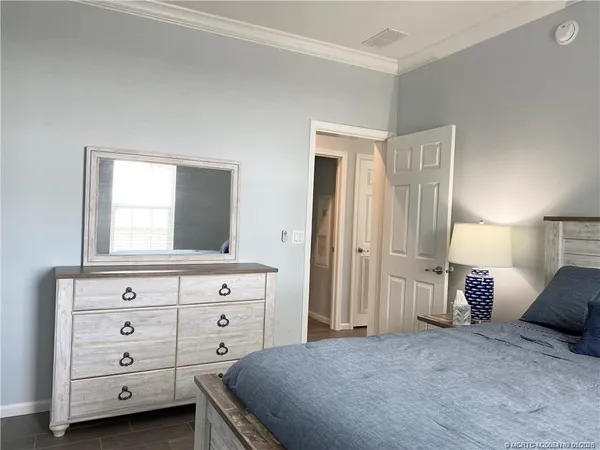 a bedroom with a bed and a dresser