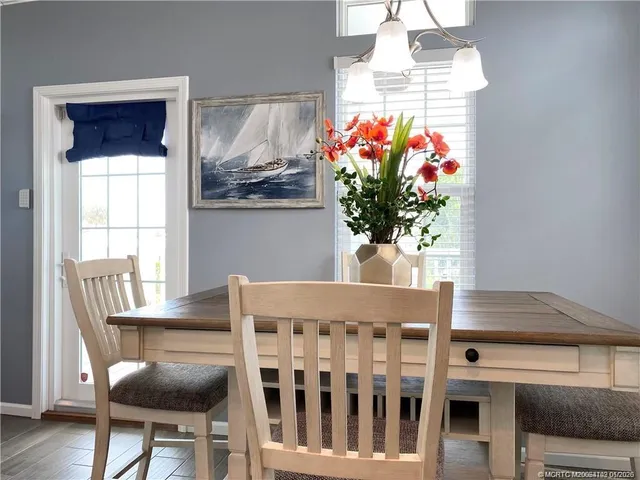 a view of a dining room with furniture and a chandelier