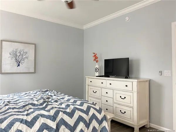 a bedroom with a bed and a television