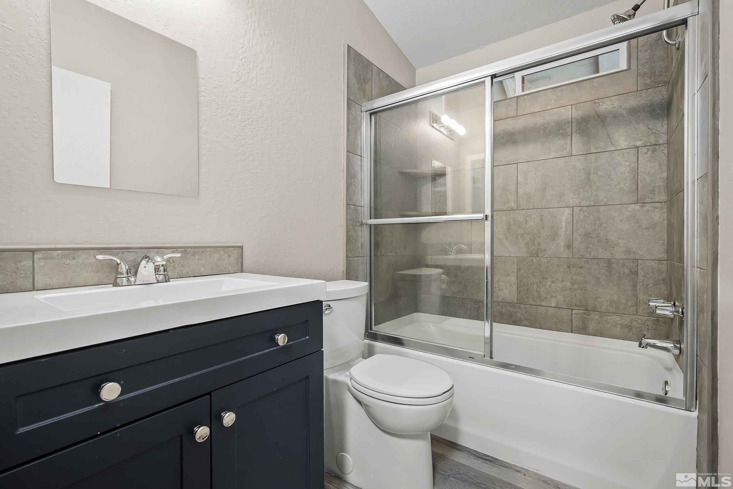 1306 Valley Creek Road Reno, NV 89523 - Photo 23 of 40 a bathroom with a sink mirror toilet and bathtub