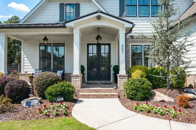 a kitchen with stainless steel appliances granite countertop a table chairs and wooden floor