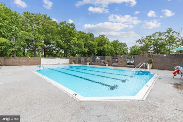 a view of a swimming pool with a yard