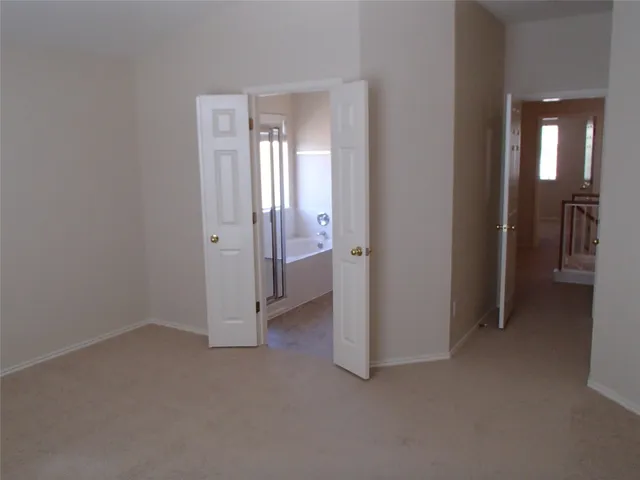 a view of a room with a hallway and closet