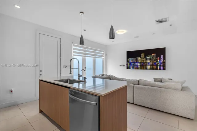 a living room with furniture and a dining table