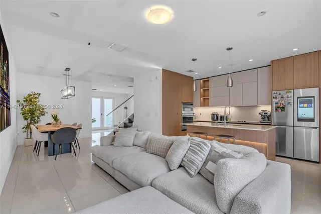a view of a dining room with furniture a chandelier and wooden floor