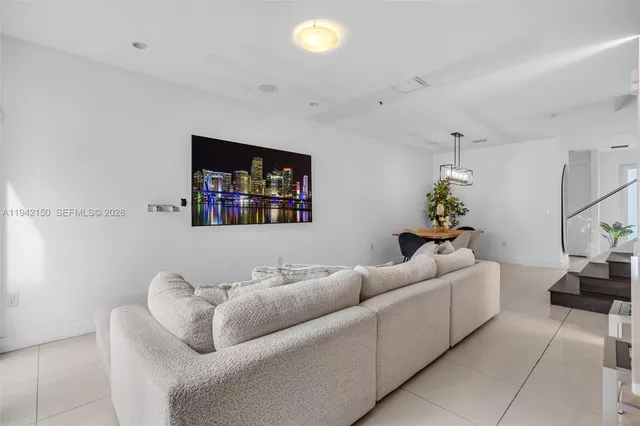 a living room with furniture and stairs
