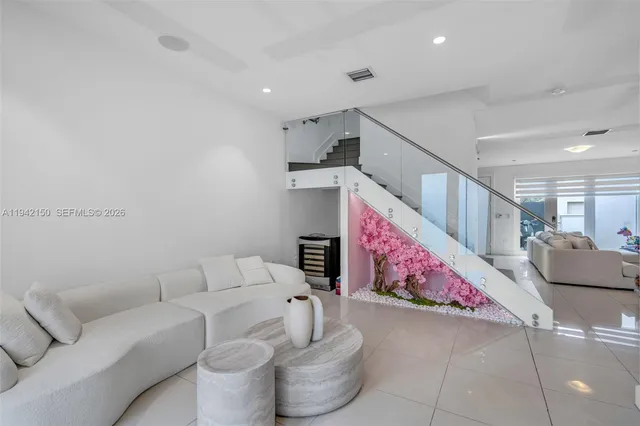 a living room with furniture and a potted plant