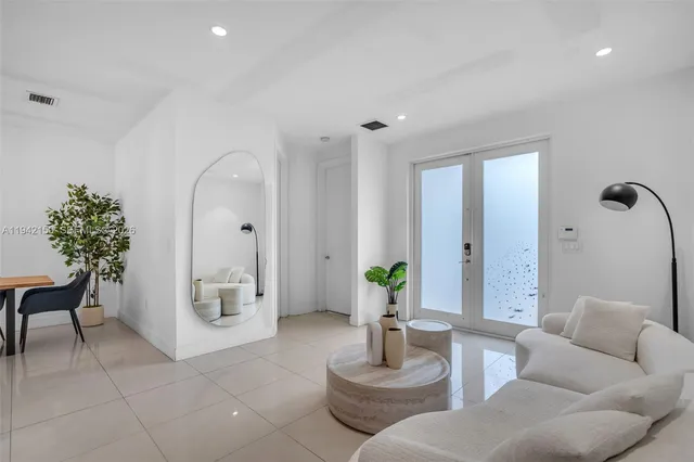 a bedroom with a large bed and a large window