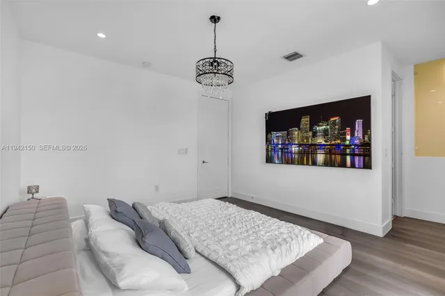 a bedroom with a bed and a table