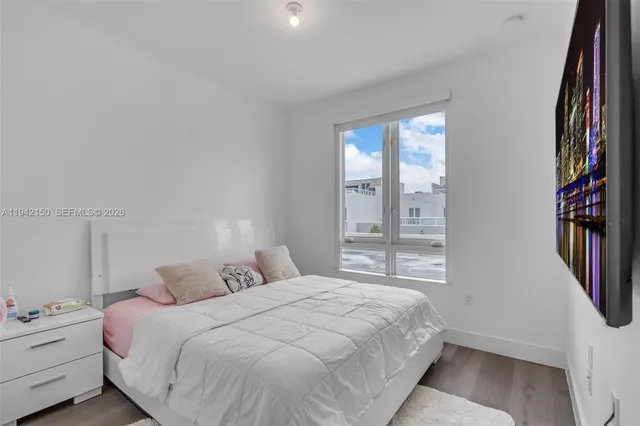 a bedroom with a bed and window