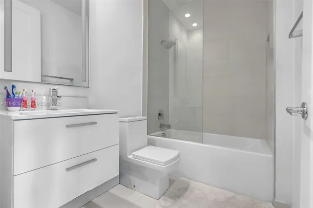 a kitchen with stainless steel appliances a sink stove and cabinets