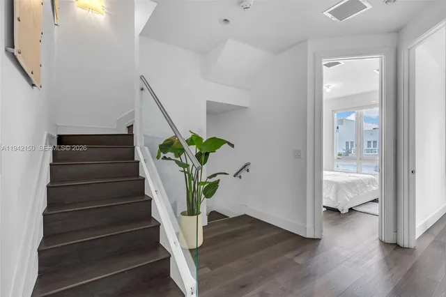 a kitchen with granite countertop a stove and a wooden floor