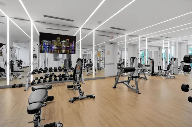 a view of a patio with couches chairs potted plants and floor to ceiling window and potted plants