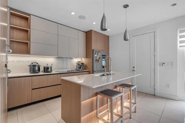 a kitchen with refrigerator and cabinets