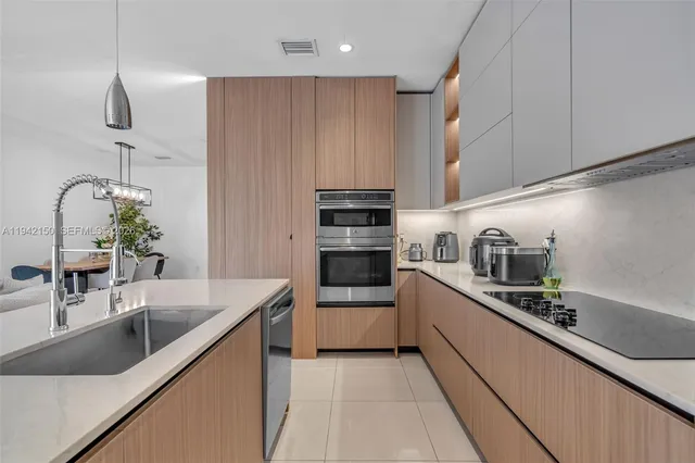 a kitchen with stainless steel appliances granite countertop a refrigerator and a stove top oven