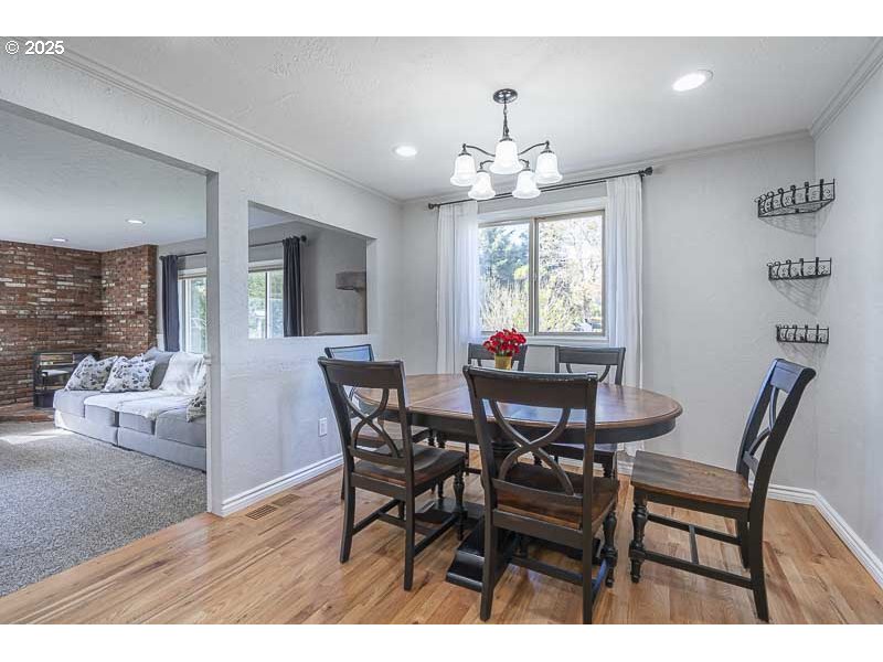 1216 Northeast Montgomery Place Albany, OR 97321 - Photo 15 of 47 a view of a dining room with furniture and chandelier