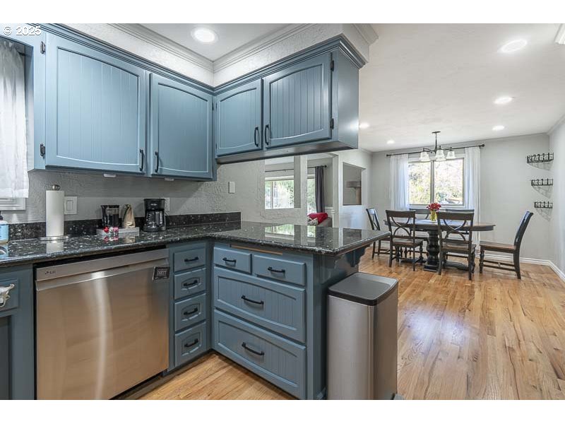 1216 Northeast Montgomery Place Albany, OR 97321 - Photo 10 of 47 a kitchen with stainless steel appliances granite countertop a refrigerator and wooden cabinets