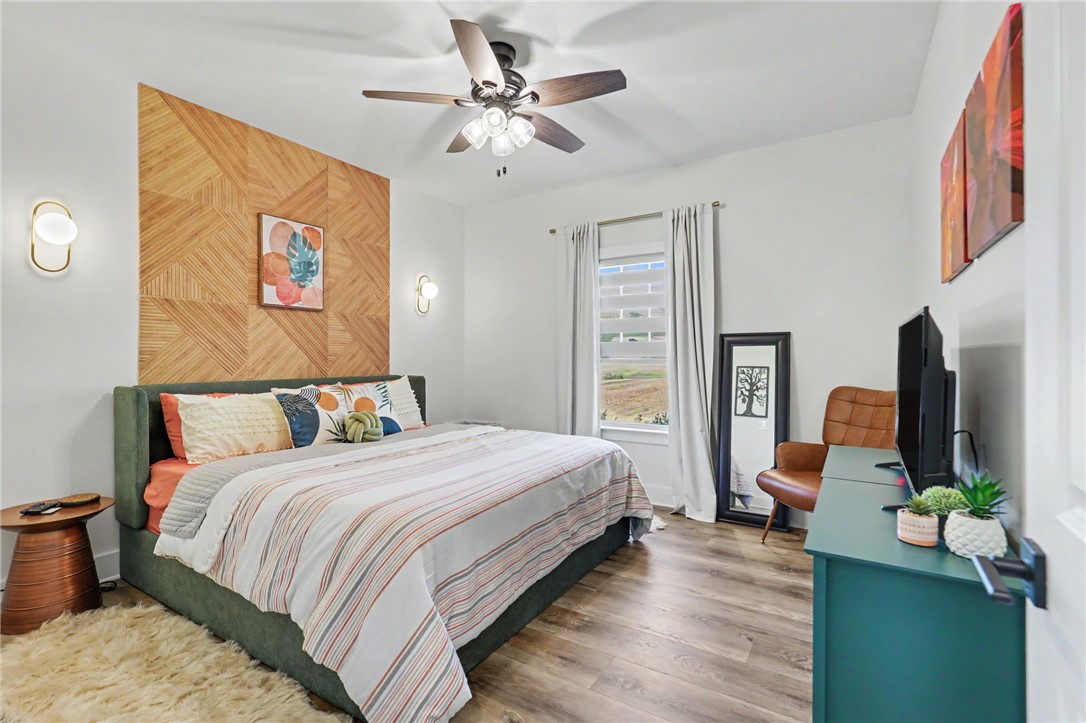 701 Coneross Creek Road Seneca, SC 29678 - Photo 23 of 35 Textured wall paneling adds character to this secondary bedroom, complemented by natural light and neutral finishes.