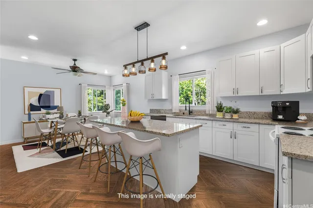 a kitchen with a table chairs stove and cabinets