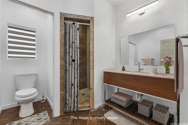 a bathroom with a toilet a sink and mirror