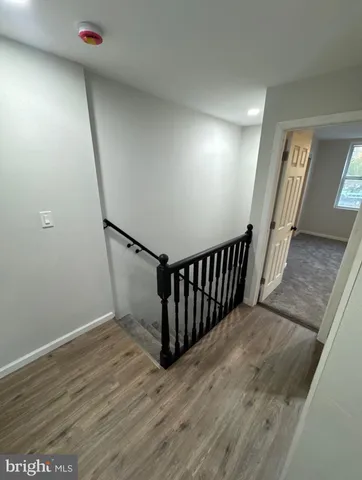 an empty room with a chair and mirror