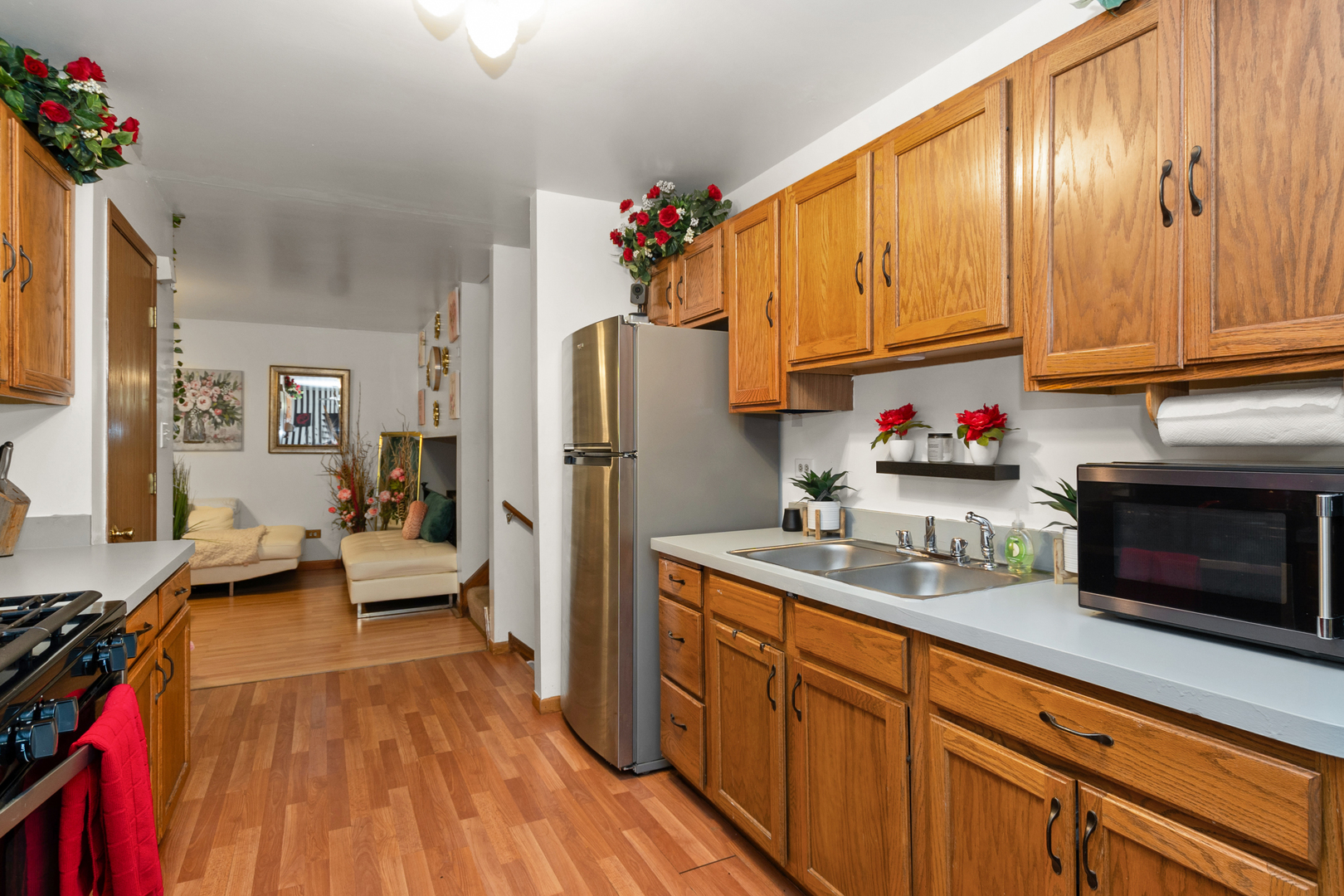 928 East 153rd Street Phoenix, IL 60426 - Photo 11 of 24 a kitchen with stainless steel appliances granite countertop a refrigerator and a stove top oven