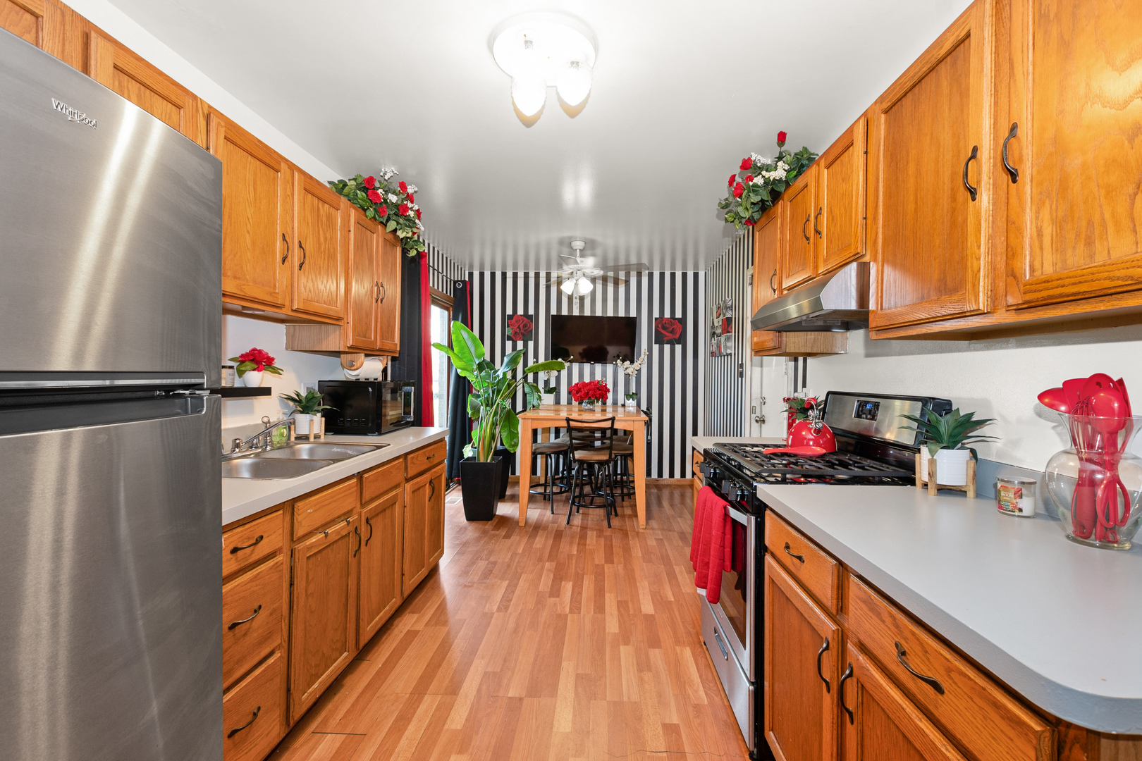928 East 153rd Street Phoenix, IL 60426 - Photo 7 of 24 a kitchen with granite countertop lots of clutter and stainless steel appliances