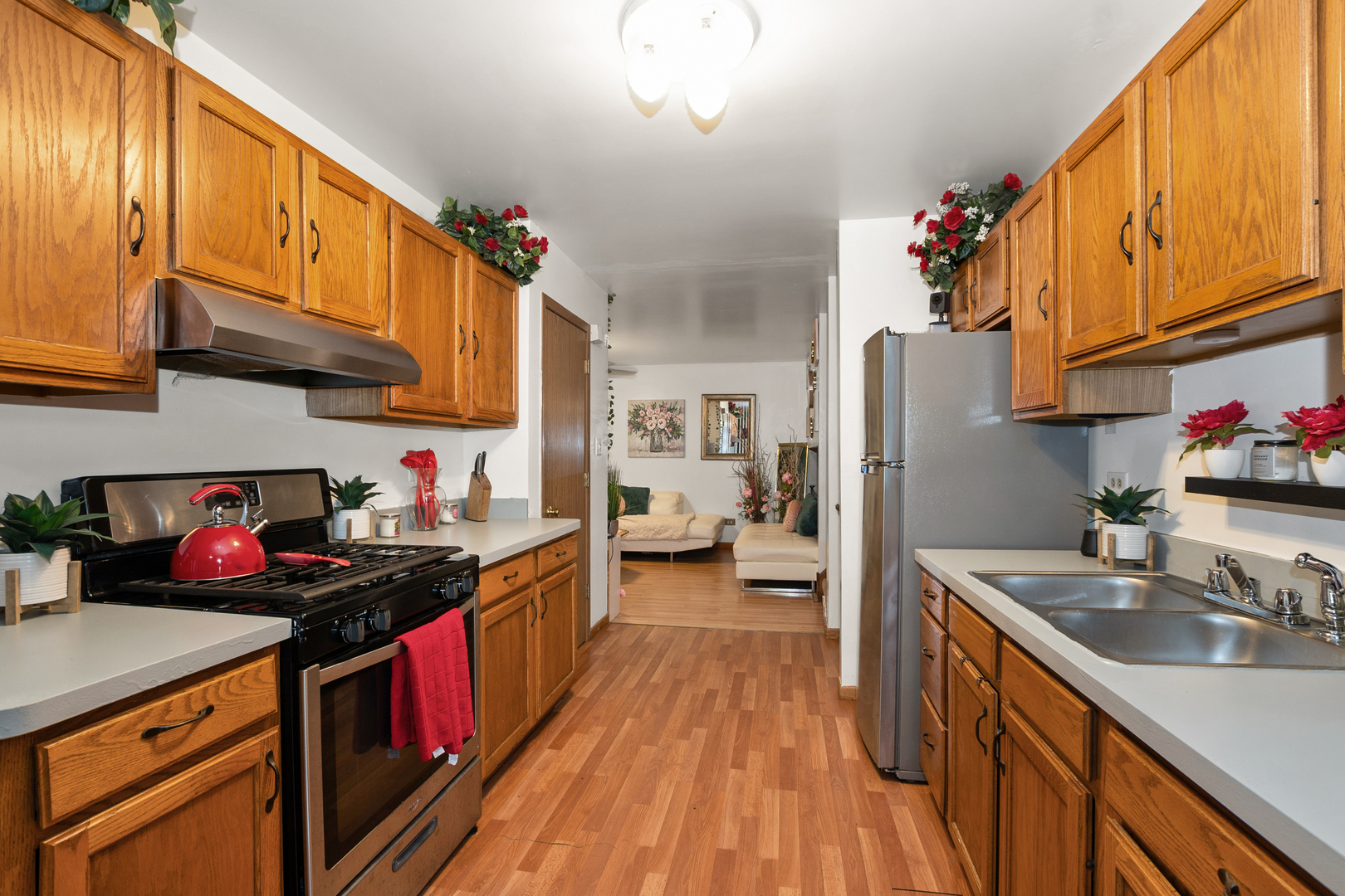 928 East 153rd Street Phoenix, IL 60426 - Photo 9 of 24 a kitchen with stainless steel appliances granite countertop a sink stove and refrigerator