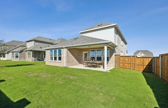 a view of a house with a yard and porch