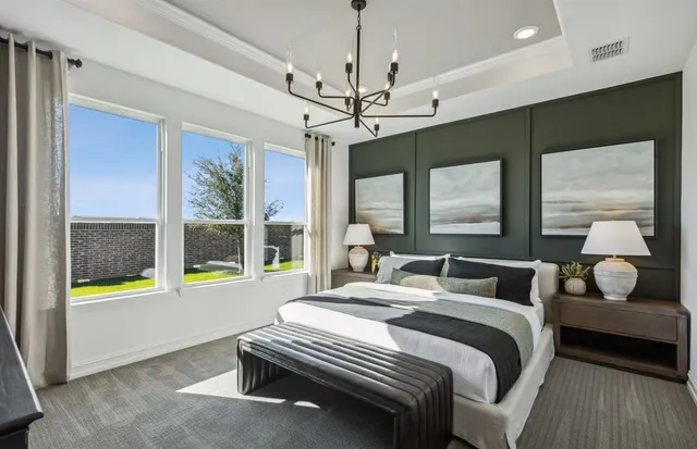 a bedroom with a bed window and a chandelier