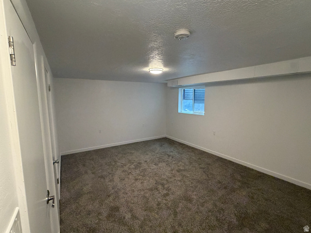 375 East 10560 South Sandy, UT 84070 - Photo 12 of 21 Room featuring a window, neutral carpet flooring, white walls, and a ceiling-mounted light fixture