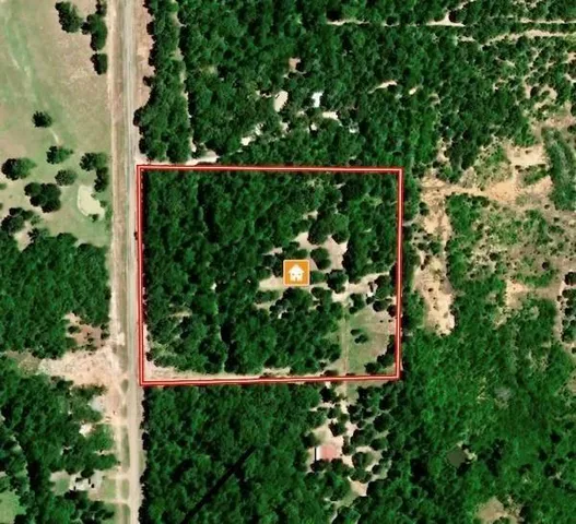 a view of a house with yard and tree in front of it