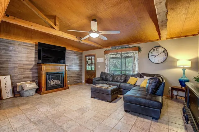 a living room with furniture and a ceiling fan