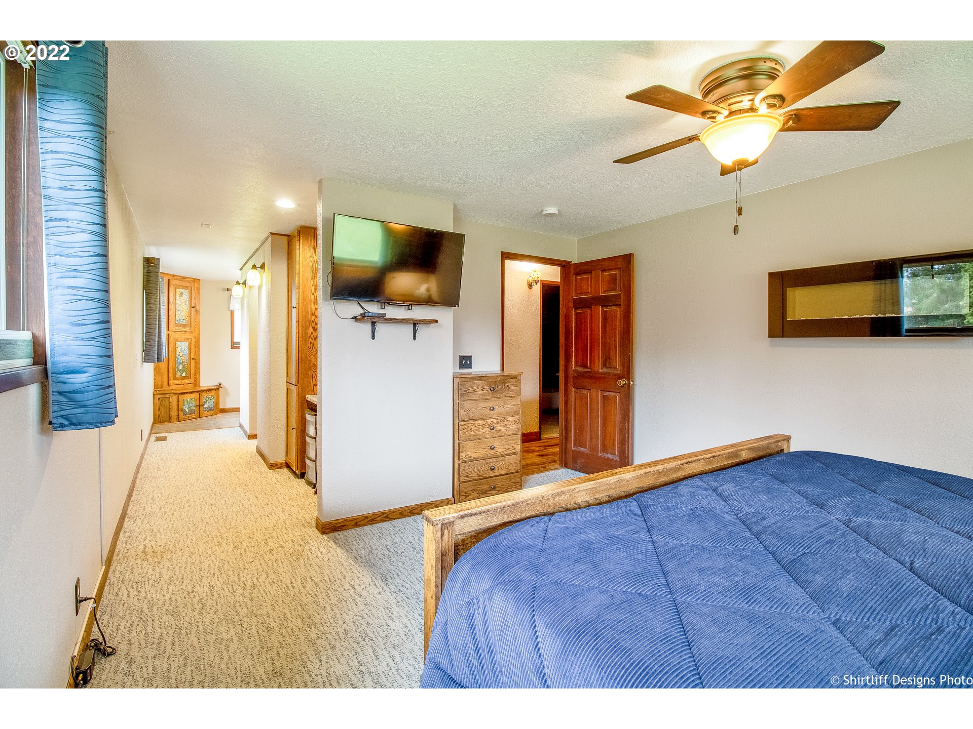 90818 Marcola Road Springfield, OR 97478 - Photo 11 of 32 a bedroom with a bed and a chandelier