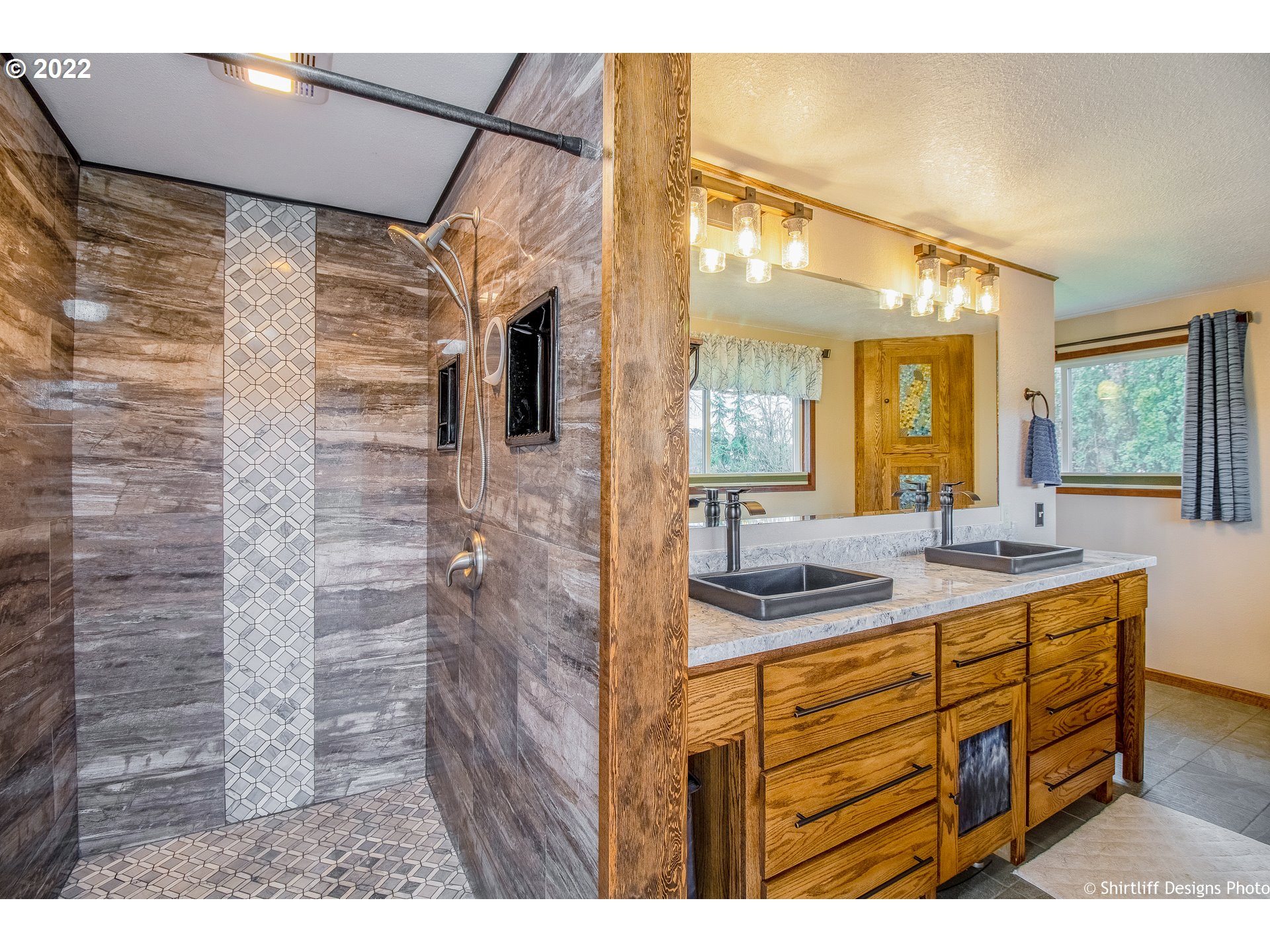 90818 Marcola Road Springfield, OR 97478 - Photo 13 of 32 a bathroom with a sink a mirror and a shower